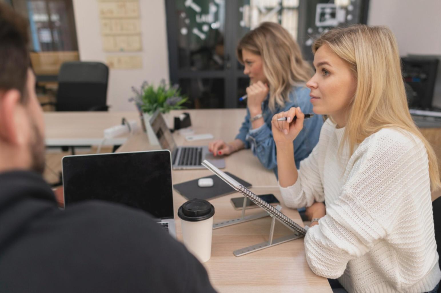 Development team collaborating on automated testing framework implementation in modern office environment